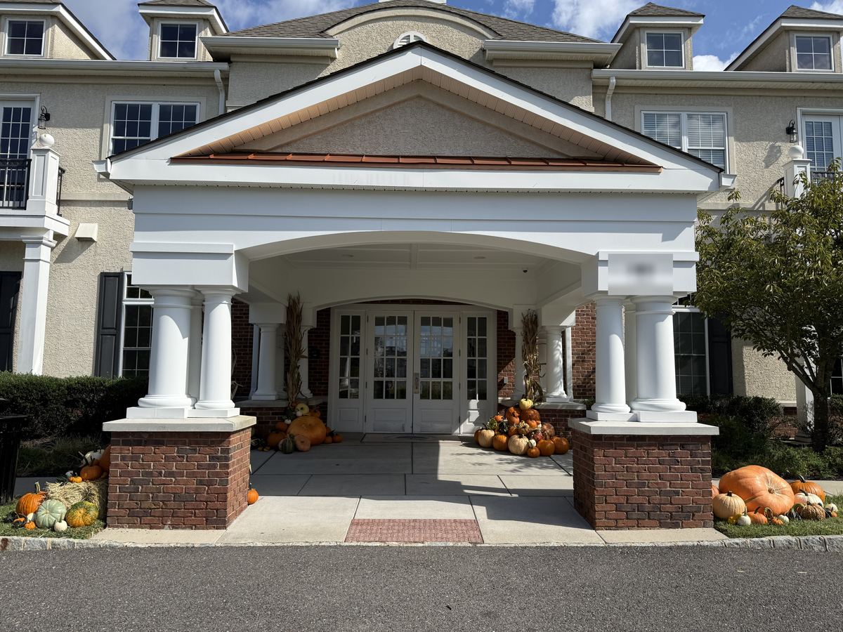 The Estate: pumpkin displays at every column of a white columned entrance